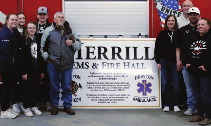 Members of the Merrill family and the new sign which will soon grace the fire and ambulance Hall. VNV photo by Lyle Van Camp