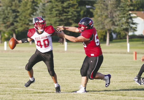 Wimpfheimer defense: Drayton junior lineman Bryce Wimpfheimer chases the White Shield quarterback out of the pocket in the season opener for the Bombers Saturday in Drayton. Photos by Mike Alan Steinfeldt.