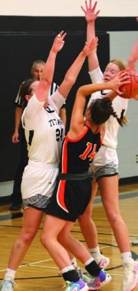 Hailey Berg and Easton Larson try to stop Cavalier's Grace Thorlakson.