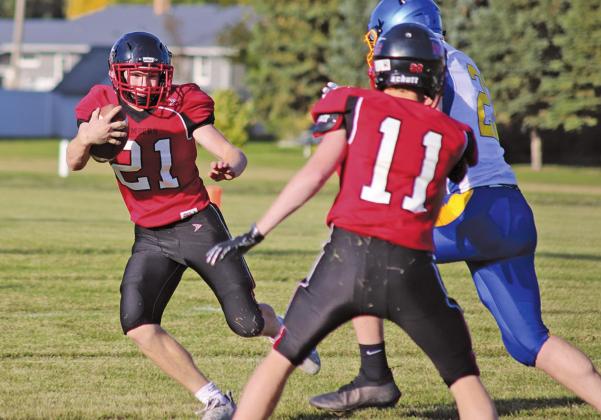 Cayden Quibell advances the ball down the gridiron while Jamie Larocque blocks a member of the Trenton Tigers team. VNV Photo by Lesa Van Camp