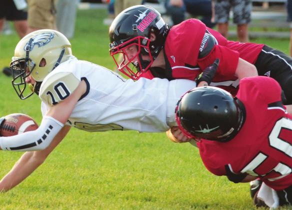 Jamie Larocque and Gavin Ryan bring down a North Border ball carrier last Friday. VNV photo by Lyle Van Camp