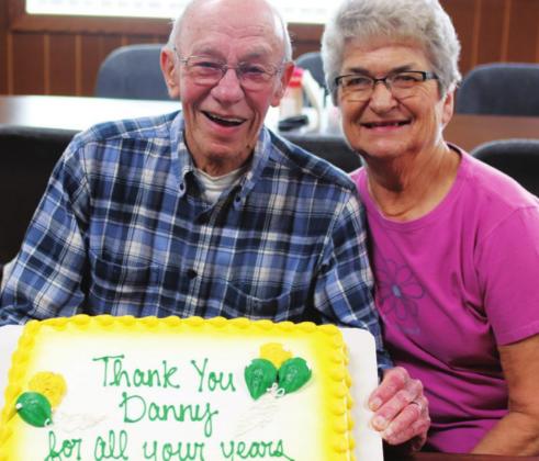 Danny and Virginia Pokrzywinski pose with the the cake seved at Danny’s retirement celebration. VNV photo by Lyle Van Camp