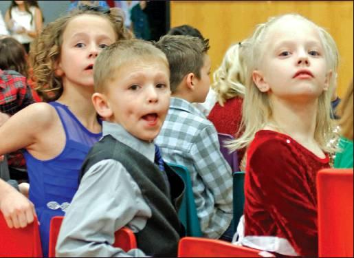 As the children entered the gymnasium they started looking for their loved ones. Pictured left to right are 2nd grade students Kendall Lizakowski, Shawn Patterson, and Nora Hillier. VNV Photo by Lesa Van Camp
